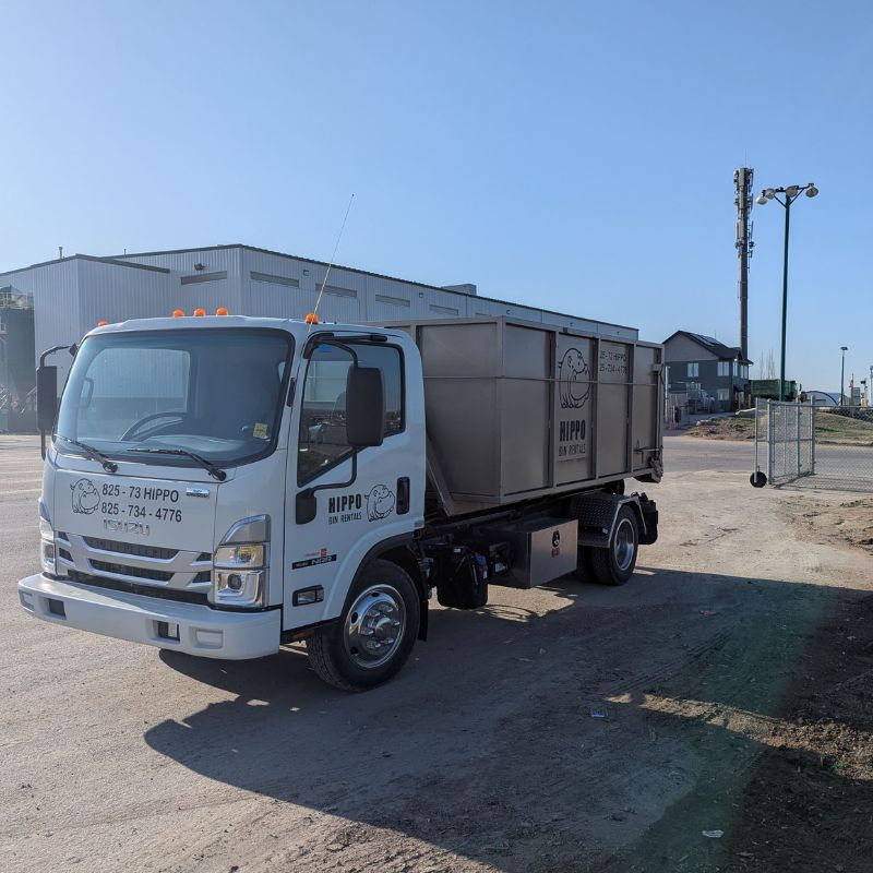 Hippo Bins Airdrie Dumpster Rental leaving storage yard